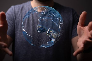 İnsan elleri arasında yüzen 3 boyutlu bir dünya fotoğrafı.