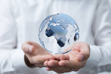 İnsan eli üzerinde süzülen 3D bir dünya fotoğrafı.