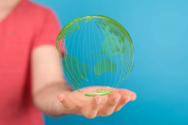 a photo of 3d rendered earth floating over womans hand