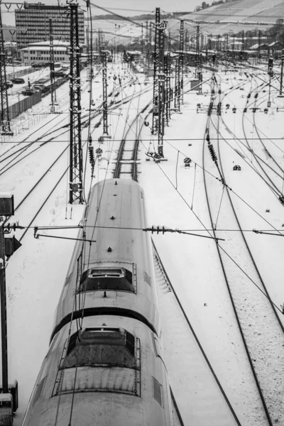 An aerial view of a train station covered in snow
