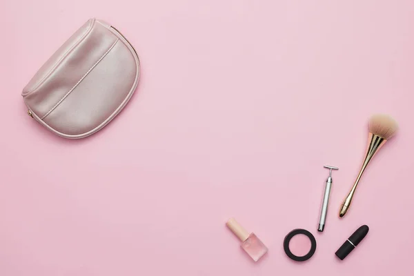 ピンクの背景に隔離された財布と化粧道具 — ストック写真