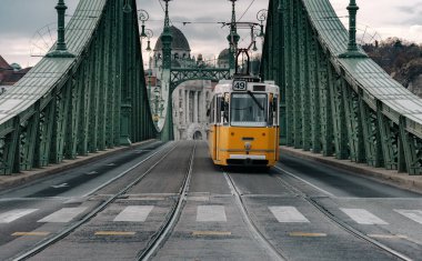 Macaristan 'ın Budapeşte kentindeki Liberty köprüsündeki Sarı tramvay fotoğrafı.