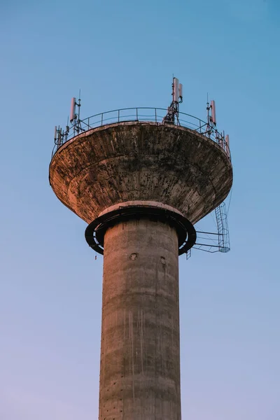 A vertical shot of an industrial tower isolated on blue sky background in Iasi, Romania