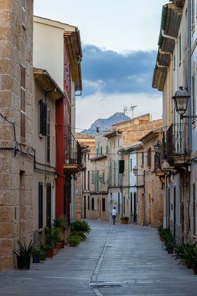 A path surrounded by aged buildings in Alcudia, Mallorca, Spain