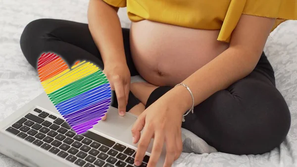 Closeup Pregnant Woman Belly She Works Her Laptop Rainbow Heart — Stock Photo, Image