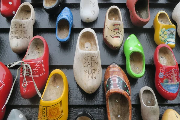Closeup Multiple Clogs Different Colors Wall Sayings — Stock Photo, Image