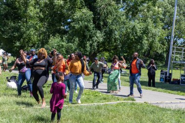 Güneşli bir günde Prospect Park Brooklyn 'de düzenlenen 13. Haziran kutlamasında bir kalabalık.