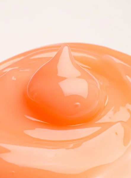 Eine Vertikale Aufnahme Einer Orangefarbenen Cremetropfen Textur Werbung — Stockfoto