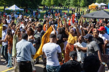 Güneşli bir günde Prospect Park Brooklyn 'de düzenlenen 13. Haziran kutlamasında bir kalabalık.
