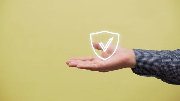 A closeup shot of a hand with the logo of a right sign definition of verify