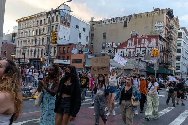Protestocular, Anayasa Mahkemesi 'nin ABD' nin NYC eyaletindeki Washington Square Park 'ta Roe V. Wade' i devirmesinin ardından vücut özgürlüğüyle ilgili mukavva tabelalar tutuyorlar.