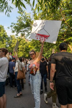 Protestocular, Anayasa Mahkemesi 'nin ABD' nin NYC eyaletindeki Washington Square Park 'ta Roe V. Wade' i devirmesinin ardından vücut özgürlüğüyle ilgili mukavva tabelalar tutuyorlar.