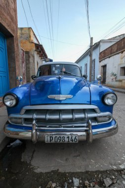 Trinidad, Küba 'da sokağa park edilmiş mavi bir retro araba.