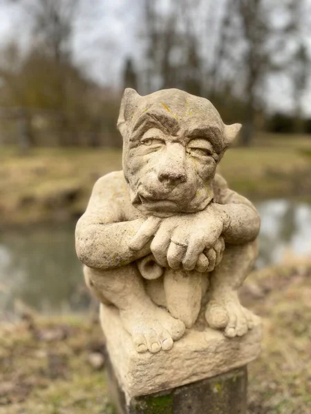 A vertical shot of a statue in a park