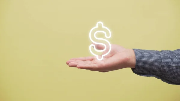 A closeup shot of a hand with the logo of the dollar currency