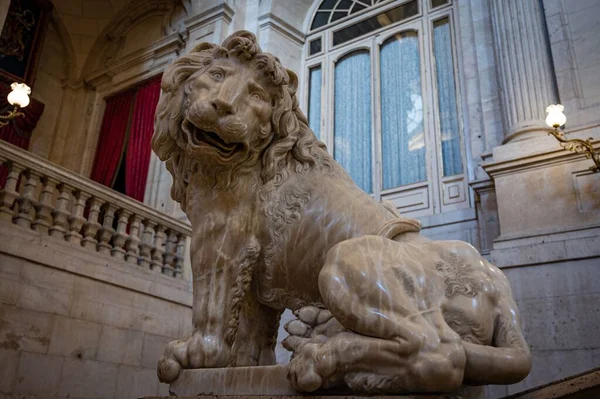 A sculpture of a male lion inside the luxurious Royal Palace of Madrid
