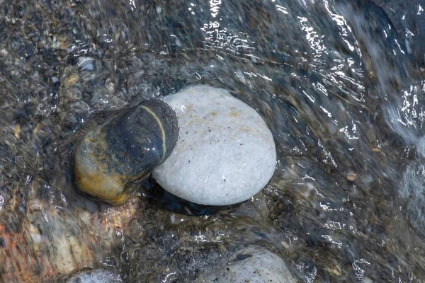 Два Маленьких Камня Пляжа Отступающей Водой Волн — стоковое фото
