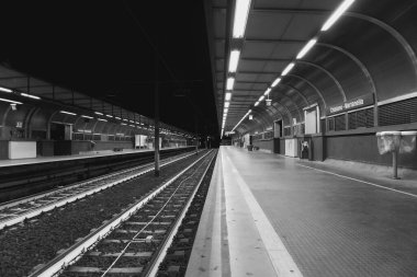 Napoli metro istasyonunun gri tonlu bir görüntüsü.