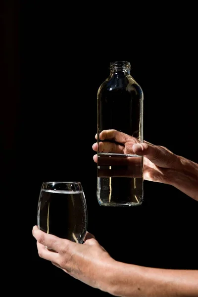 Una Toma Vertical Manos Sosteniendo Una Botella Vaso Lleno Agua — Foto de Stock