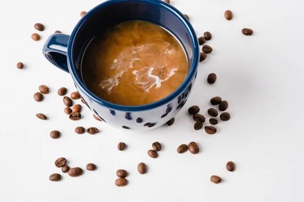 コーヒーの広告のための白い表面の大きい考えの豆とコーヒーのコップの上の眺め — ストック写真