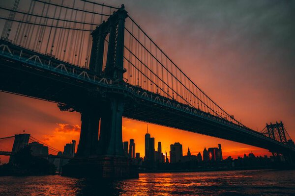 Vibrant scenery of Manhattan Bridge at bright sunset, USA