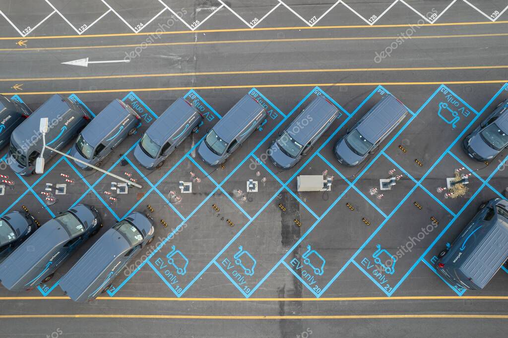Top view of Amazon Prime electric delivery vans, parked at   the logistics hub of Amazon. Turin, Italy - July 2022