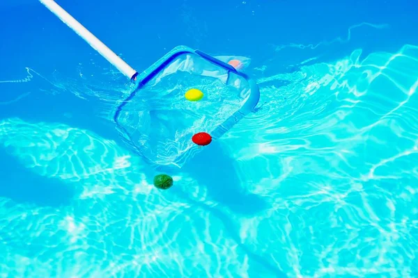 Closeup Shot Hand Fishing Net Collecting Colorful Balls Pool — Stock Photo, Image