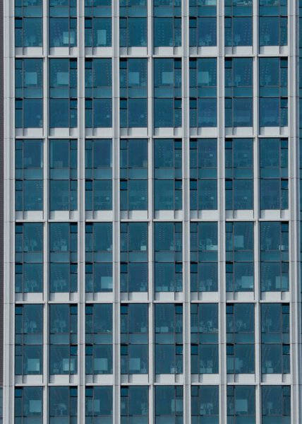 A vertical closeup of modern skyscraper made with glass