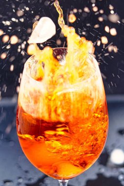 Bir İtalyan kokteyli olan Spritz Veneziano ile dolu bir bardağın dikey yakın çekimi.