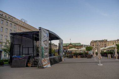 Sıcak bir yaz öğleden sonrasında Plac Wolnosci meydanında boş bir sahne ve içkili yiyecek duruyor..