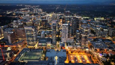 An aerial shot of the lit-up city of Bellevue at night in Washington State clipart