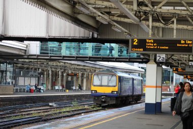 Bir Kuzey Trenleri 'Pacer' ı ve Sheffield, Güney Yorkshire, İngiltere 'deki bir tren istasyonundaki yolcuların fotoğrafı.