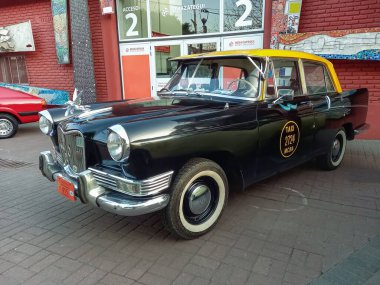 Yaşlı Siam Di Tella Riley 1500 sedan 1959 - 1967 cadde. Buenos Aires 'te geleneksel siyah ve sarı taksi. Klasik araba şovu..