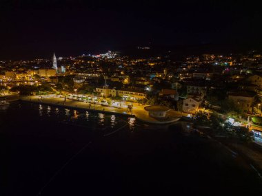 Supetar, Brac, Hırvatistan şehir manzarasının gece vakti havadan çekilmiş bir drone görüntüsü.