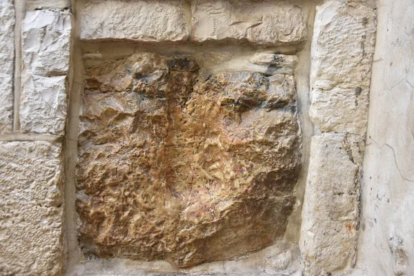 A closeup shot of the handprint of Jesus n the stone in Jerusalem