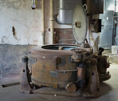 Terk edilmiş çamaşırhanede bir çamaşır makinesi.