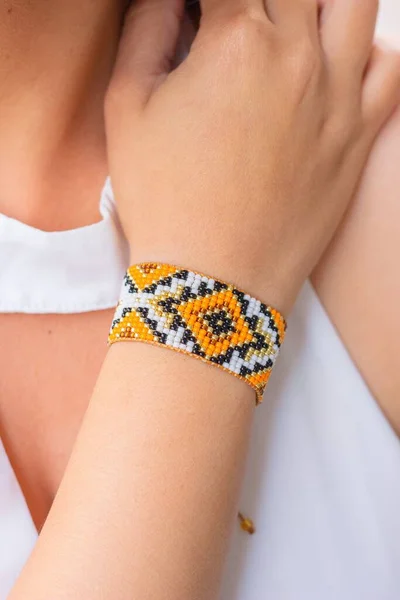 Vertical Closeup Yellow Patterned Bead Loom Bracelet Caucasian Female Hand — Stock Photo, Image