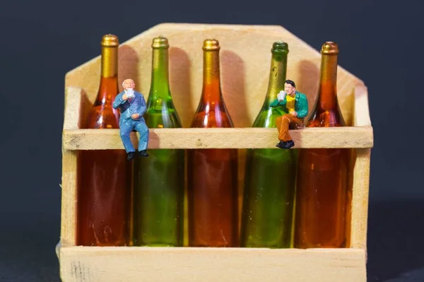 Wine Drinkers Sitting Wooden Shelf Filled Wine Bottles Closeup Dark — Stock Photo, Image