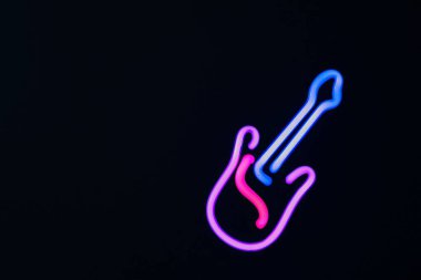 Siyah arkaplanda gitar çizgisi olarak parlayan renkli neon ışıkları