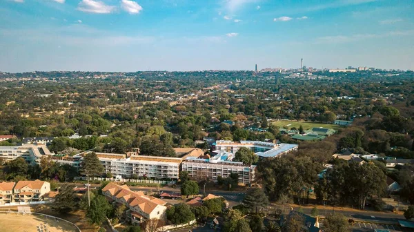 An aerial view of buildings and trees in Johannesburg, South Africa