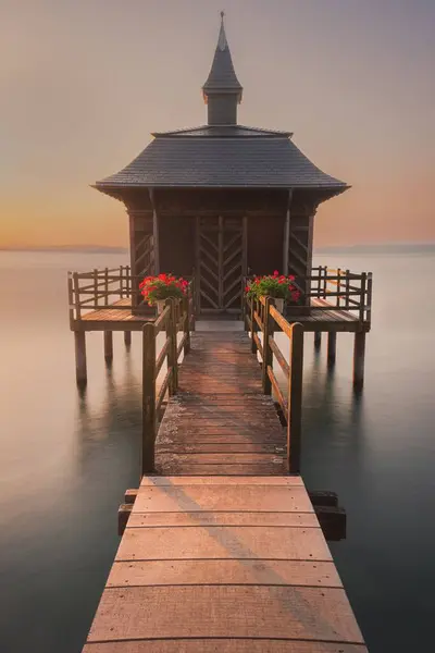 背景には水景のある日没時の木の亭と遊歩道の垂直撮影 — ストック写真