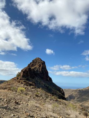 Gün ışığında kayalık tepenin dikey görüntüsü.