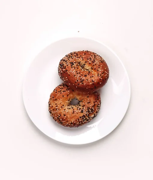 Vertical Shot Two Doughnut Shaped Bagels Plate White Background — Stock Photo, Image