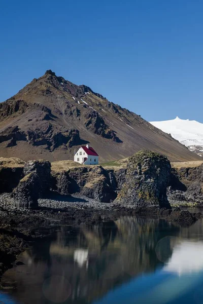 冰岛Snafellsnes半岛岩层附近一座房屋和一个湖泊的垂直拍摄 — 图库照片