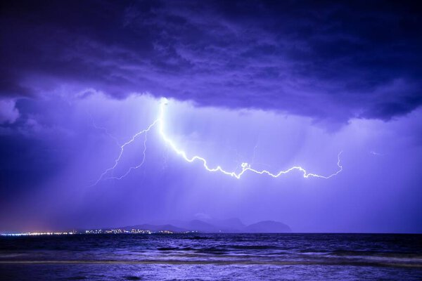 The beautiful view of the thunderstorm with lightning above the sea.