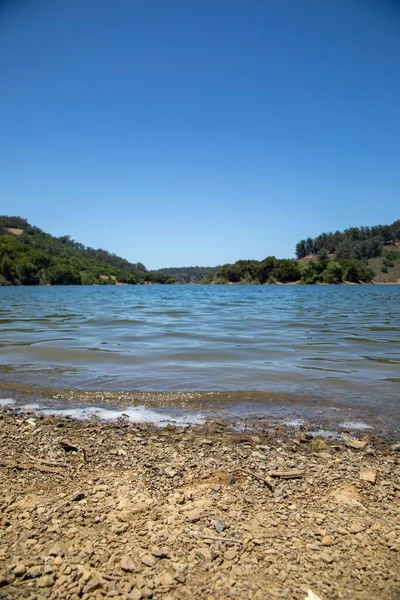 Primo Piano Verticale Piccole Pietre Sulla Riva Bellissimo Lago Blu — Foto Stock