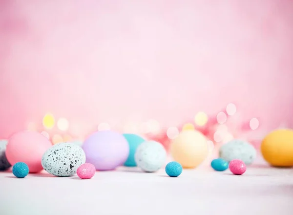 A closeup shot of colorful Easter eggs isolated on the pink background