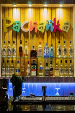 Barın arka planı şişelerle dolu.