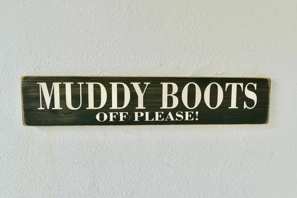 Closeup Muddy Boots Please Sign White Wall — Stock Photo, Image