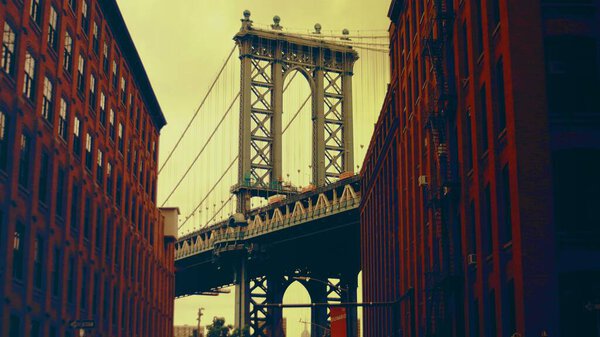 A low angle view on suspended bridge in New York, Manhattan bridge with amazing view on skyline